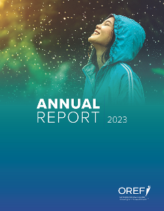 Cover of the 2023 OREF Annual Report A woman in a blue raincoat lets the drops fall on her face.