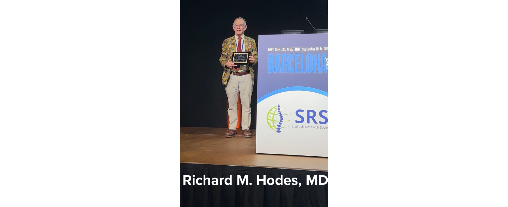 Richard M. Hodes, MD receives a plaque as the 2024 Scoliosis Research Society Walter P. Blount Award winner